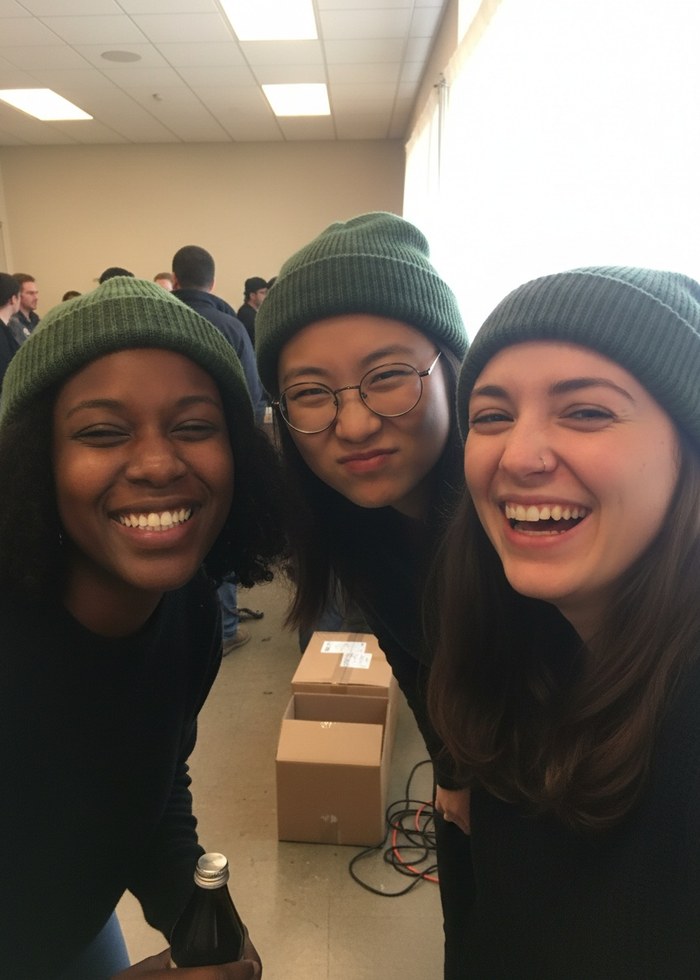 Three friends in beanies and NarrowPath caps posing in a Natures Relax photo frame
