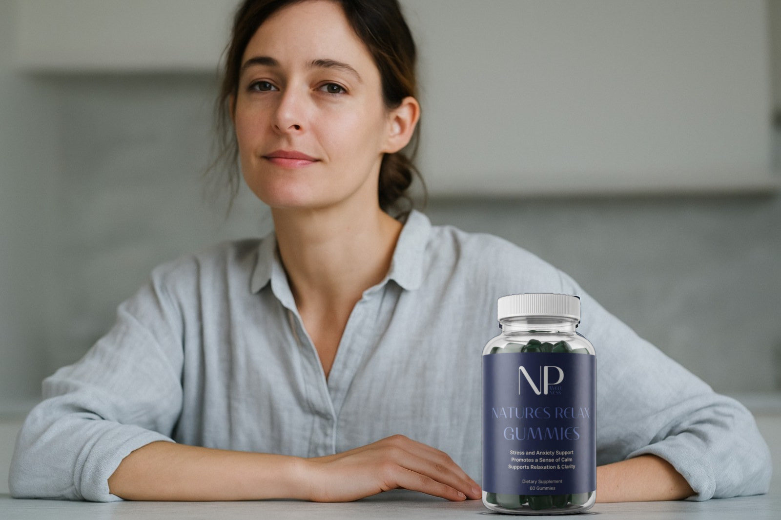 A woman at a kitchen table beside a bottle of Natures Relax Gummies
