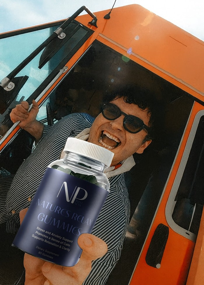 A laughing driver leaning from an orange truck holding a NarrowPath Natures Relax Gummies pouch